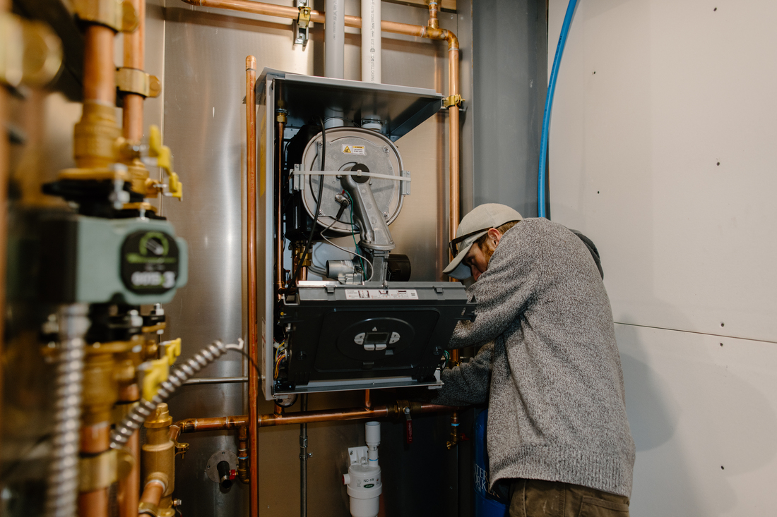 contractor working on tankless water heater