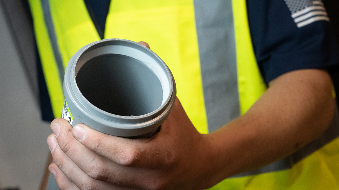 contractor holding pp vent pipe